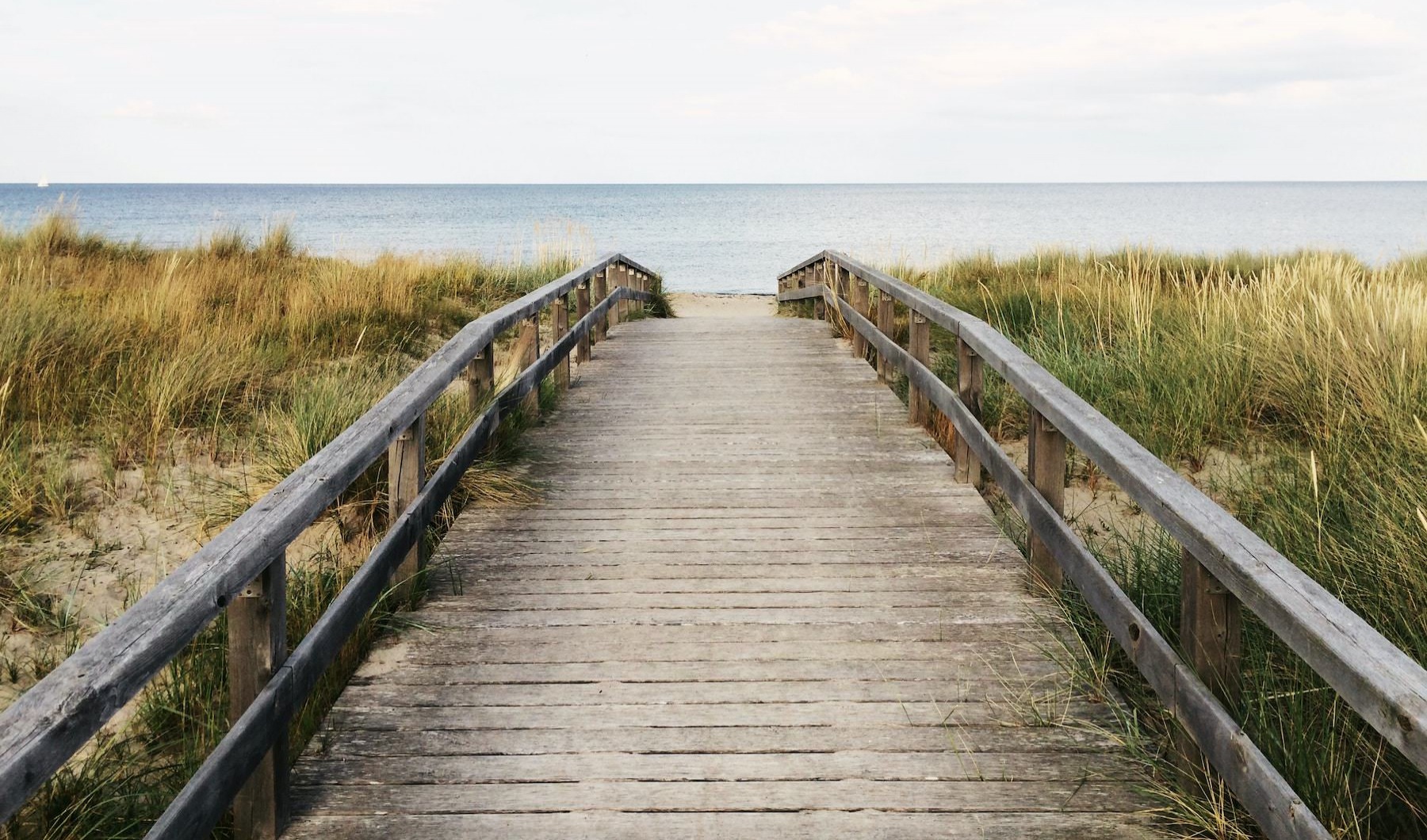 Long wooden boardwalk leading to the ocean 